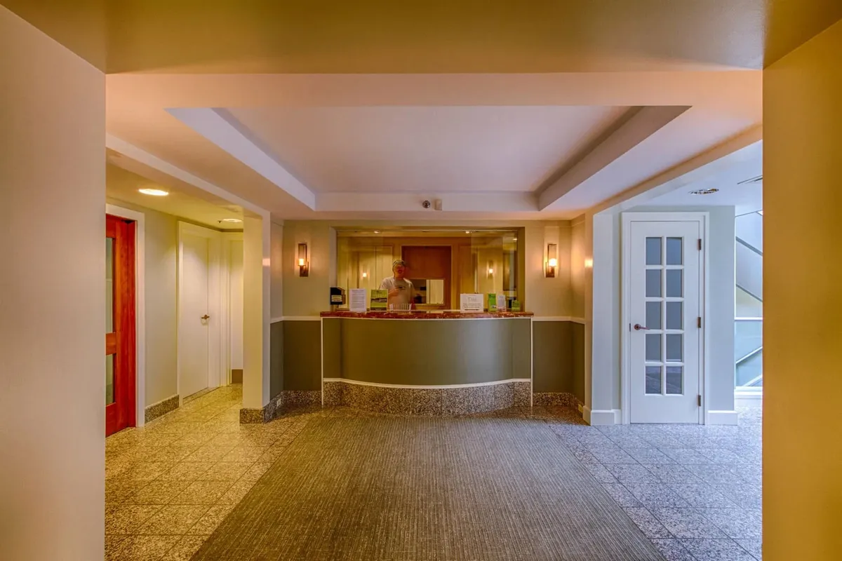 This image highlights the inviting reception desk area, warm light fixtures, and open doorways that suggest easy access to the resort’s amenities. The space feels welcoming and organized, setting the tone for a resort experience where adventure and relaxation are seamlessly integrated.